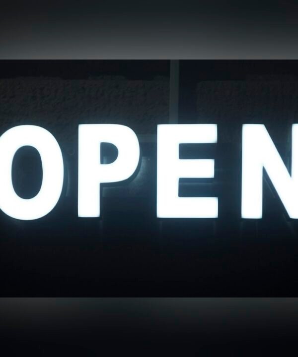 Front lit trim cap letters spelling OPEN