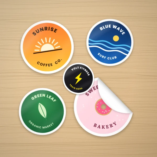 Custom circle stickers with logos on a wooden desk