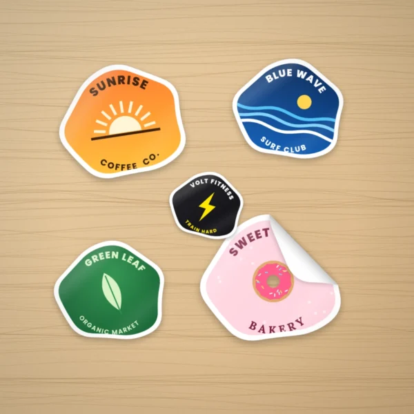 Custom custom shape stickers with logos on a wooden desk